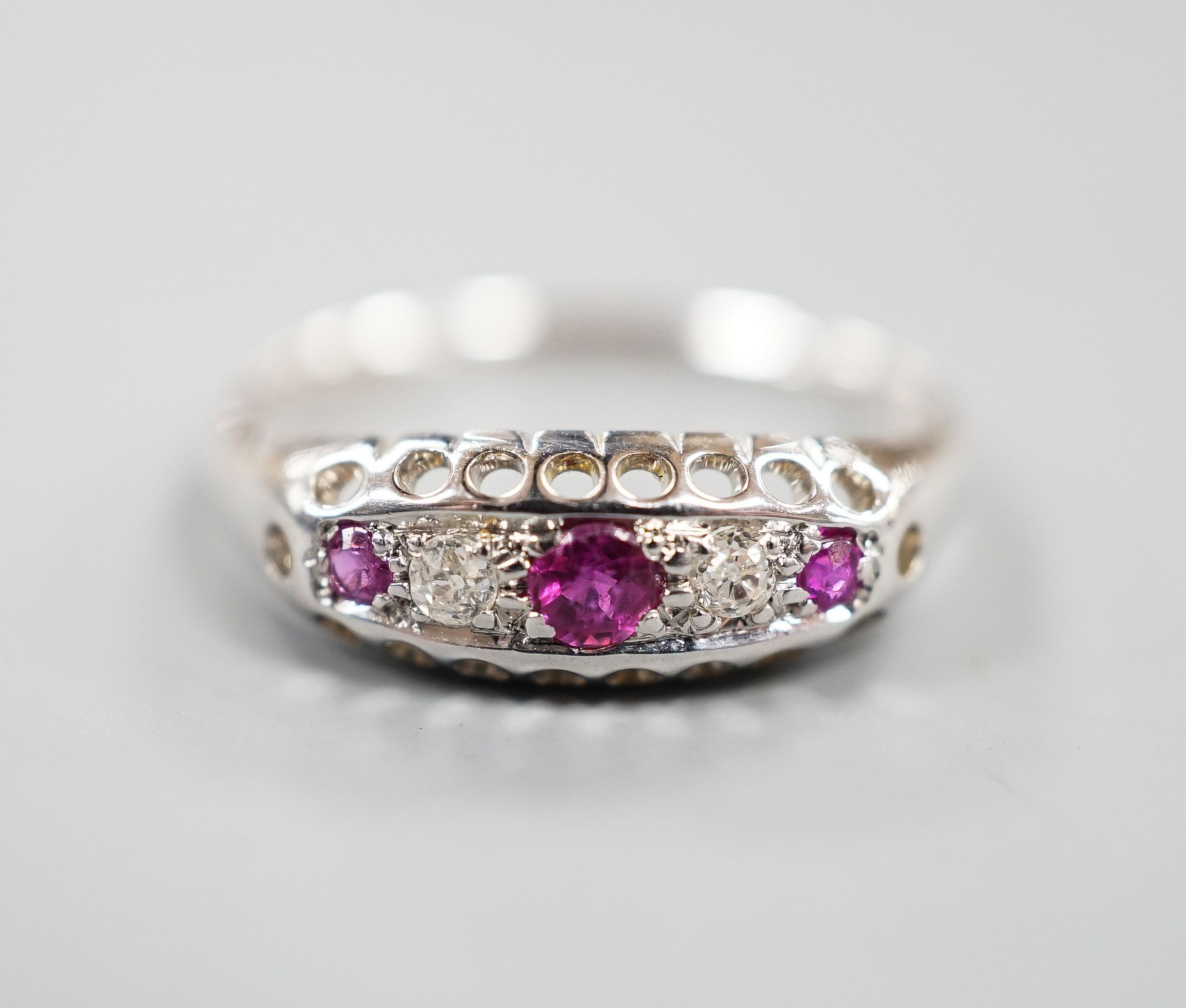 A George V 18ct white gold three stone ruby and two stone diamond ring, size P/Q, gross weight 2.3 grams.